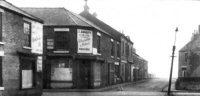 Coupland Place, off Nottingham Road, Somercotes. A photograph of the centre of Coupland Place, with the shop and warehouse of J Abbott & Co, on the corner. The photograph dates from the early 1970s.