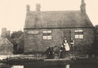 The Old House at Home Inn on the canal between Pye Bridge and Pinxton. The Ladies are standing in a punt which was used to carry customers across the canal to the Inn.