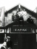 The Empire Cinema Somercotes, Nottingham Road. Pictures the entrance to the Cinema.Photograph of the Empire Cinema dates from 1931. Evelyn Brandon is the manager, on left with the hat. Her daughter on the photo is Grace Brandon and the boy at the front is Roger Brandon.