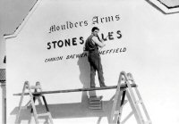 One of the Hill Brothers painting the Moulders Arms sign