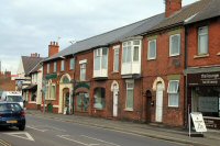 Somercotes, Nottingham Road. A photograph taken of the buildings at the junction with the High Street. The building, Oporto House, was once owned by George Beastall, a prominent Somercotes figure. The photograph dates from 2012.