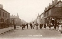 Nottingham Road at the Junction of High Street Slacks Newsagents shop on the right. This photograph also shows the large Billboards that stood on the junction with High Street.