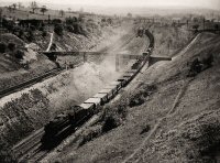 Steam Train at Red Bridge old wooden bridge over Cotes Park line in background.